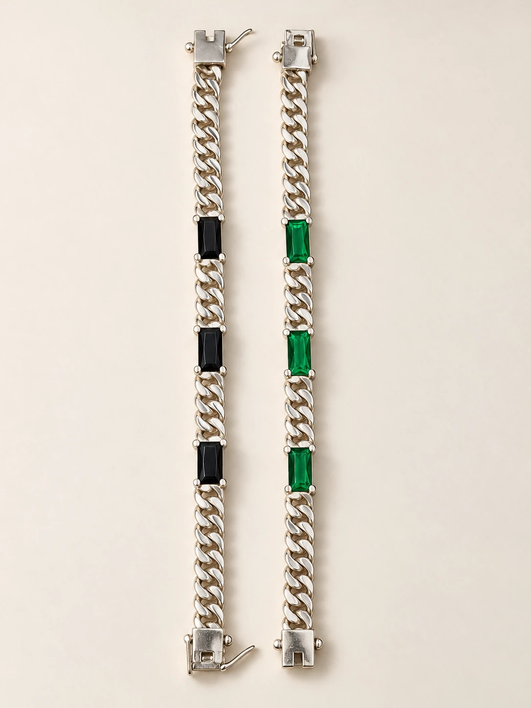 Two chain bracelets with three rectangular insets each, one green and one black