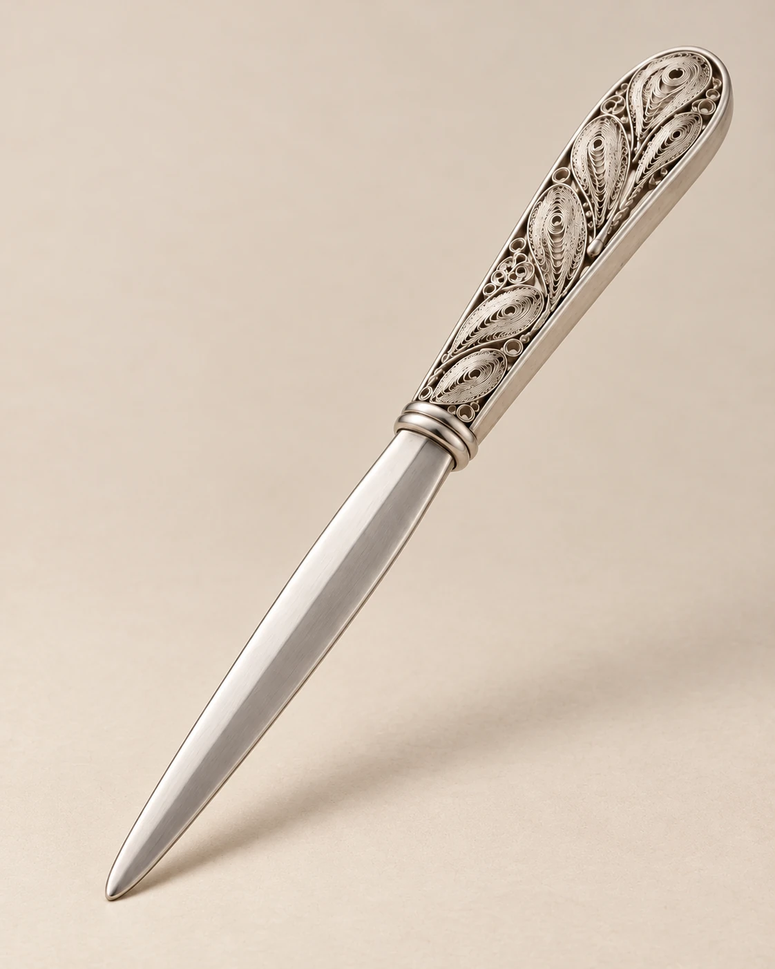 Proposed functional view of the filigree letter opener and its blade beside an envelope